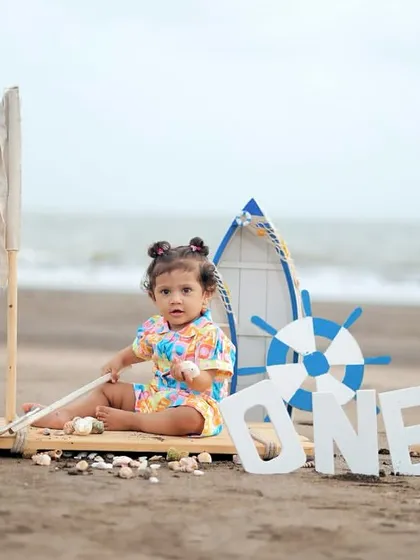 A cute portrait of the birthday girl sitting on her mini-boat Zahlen, ready for her sea adventure.