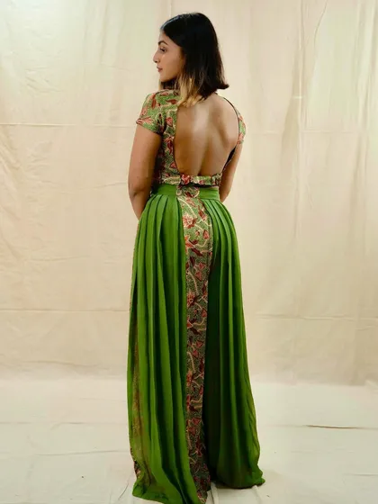 A back view of this stunning green and floral embroidered outfit from Saga by Kinjal. The open-back design is a modern twist on a traditional silhouette.