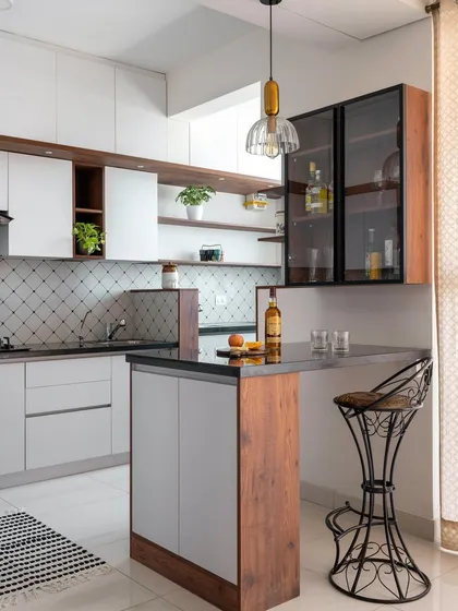 For this home with limited communal space, we designed a compact bar and breakfast counter adjacent to the kitchen, creating a versatile hub for entertainment and quick meals.