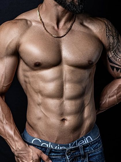 A close-up on the results of our 100-day cut. Notice the defined abdominal muscles and vascular arms, achieved through a strict diet and training regimen.