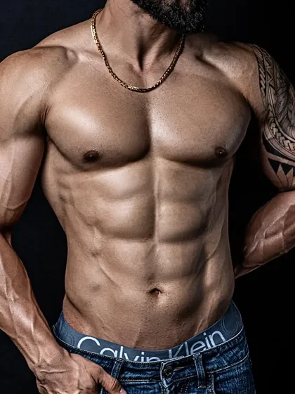 A close-up on the results of our 100-day cut. Notice the defined abdominal muscles and vascular arms, achieved through a strict diet and training regimen.
