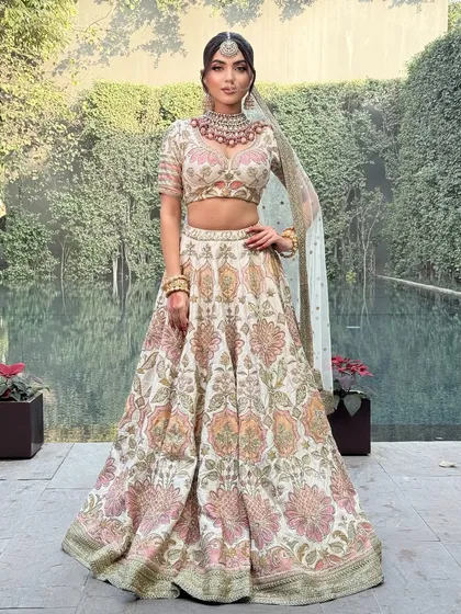 Another perspective of this gorgeous Sabyasachi lehenga, highlighting its flow and grace against a natural, green backdrop.