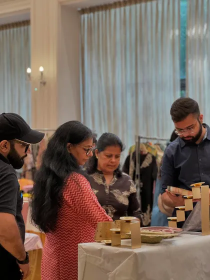 A vendor demonstrates a product to curious shoppers. This hands-on experience is something online shopping can't replicate.