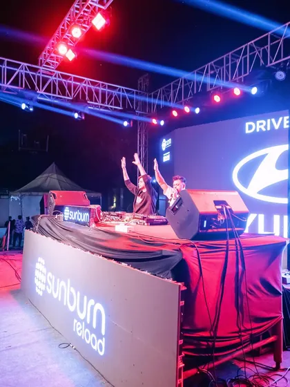 On stage at Sunburn Reload for a massive corporate event with Hyundai. I’m not just a DJ, I'm on the mic, hyping up thousands and making sure everyone is part of the show.