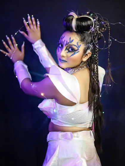 A dynamic pose showing the fairy lights woven into the hair and costume, adding a magical glow to the overall look.