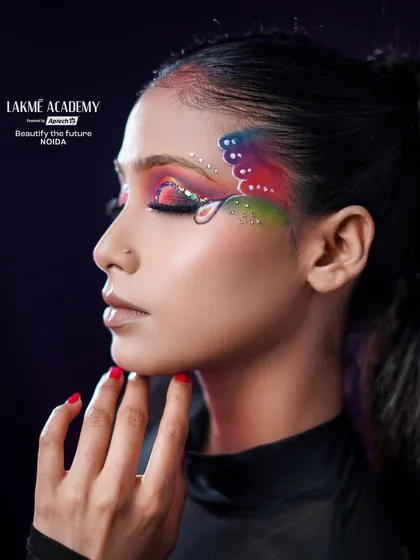 A close-up of a butterfly-inspired Brazilian eye makeup look. The colorful wings and rhinestone details showcase incredible creativity and precision.