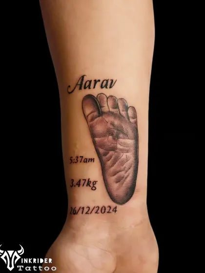 We create memorial tattoos that honor your most precious memories. This piece immortalizes a child's footprint with their name and birth details, providing a beautiful and permanent tribute for a parent to carry with them always.