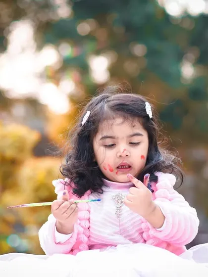 A little paint on the face is all part of the fun. These candid shots often become the most cherished memories.