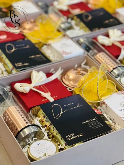This luxury Diwali hamper includes a variety of premium items like a copper-infused water bottle and scented candles, all beautifully arranged in a custom box. It's a perfect high-end corporate gift.