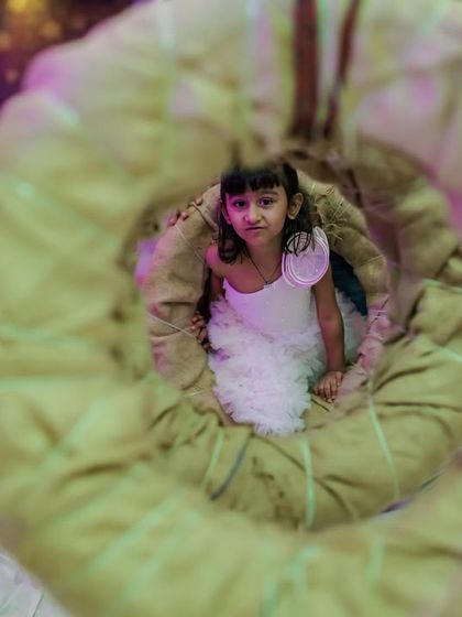 A creative shot through a tire swing, capturing a child enjoying the play area. I focus on creating visually interesting setups that are great for photos.