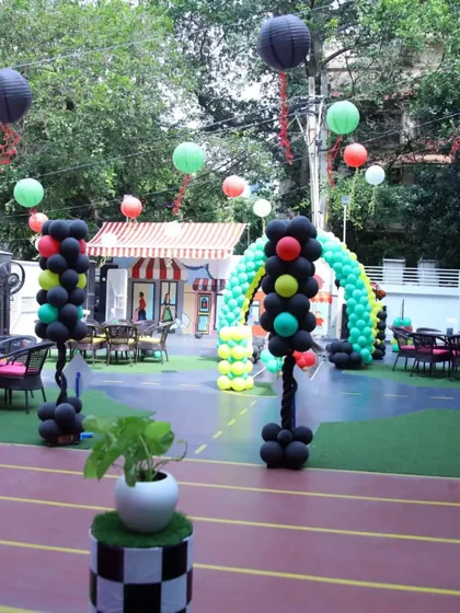 Our outdoor space fully decorated for a 'Cars' theme party, with balloon traffic lights and hanging lanterns creating a festive atmosphere.