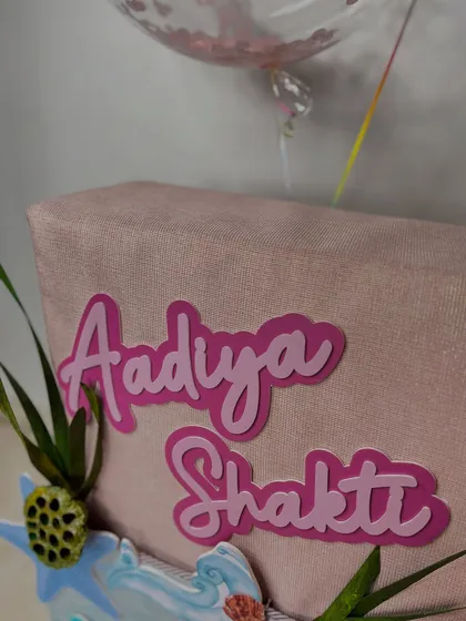 The personalized nameplate in layered pink acrylic, a key feature that makes this beautiful mermaid-themed gift feel truly special and unique.