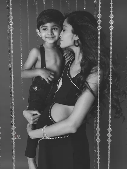 The same sweet moment in black and white. This version feels so classic and emotional, highlighting the strong bond between mother and son.