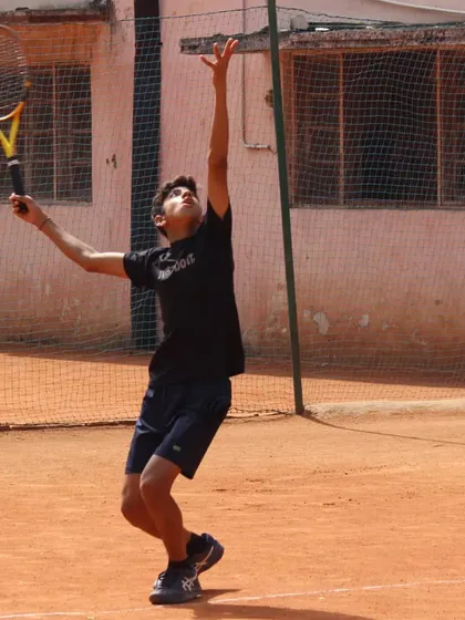 The trophy pose. A young player showing a perfect service motion, a technique we drill from day one.