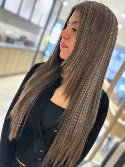 A cool blonde highlight blend styled straight to show off the sleek, blended color. This look is sophisticated and modern.