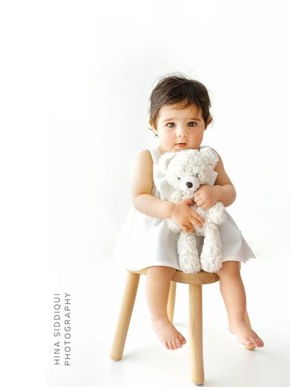 Holding her teddy bear close, this portrait is full of innocence. The simple setup ensures that the emotional connection between the child and her comfort object is the central story.