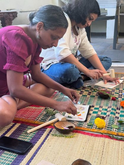 Two participants working side-by-side, arranging flowers on their respective projects. My workshops often have a calm, communal atmosphere where everyone can unwind and create at their own pace.