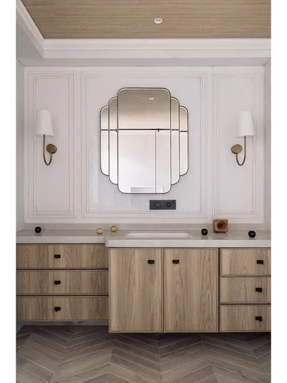 A full view of the vanity in the den, showing the herringbone wood flooring and classic wall paneling. Every detail is thoughtfully considered to create a cohesive look.