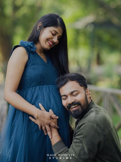 Pure joy captured in a candid moment. The dad-to-be listens to the baby bump with a huge smile, creating a heartwarming and authentic photograph.