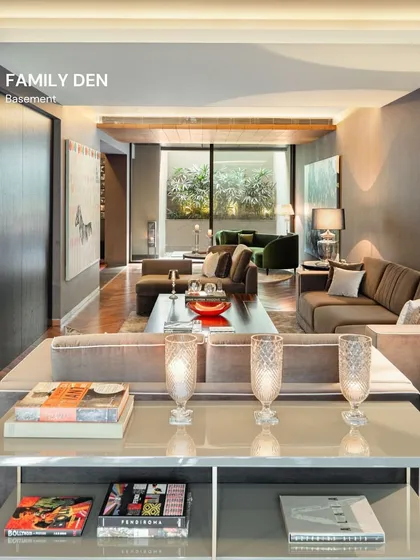 The basement family den was designed as a cozy, intimate retreat. We used darker tones, plush sofas, and soft lighting to create a perfect environment for movie nights and quiet relaxation, with a sunken courtyard bringing in a surprising amount of natural light.