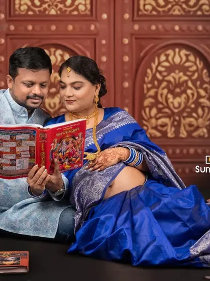Sharing a quiet moment together, this couple reads a book to their unborn baby. This pose adds a personal and sentimental layer to their traditional maternity session, capturing their anticipation and love.