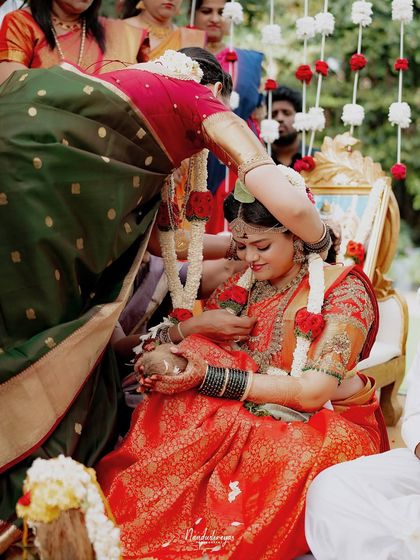 A mother blesses her daughter, the bride, during a traditional ceremony. This is a powerful, emotional moment that speaks to the deep bonds of family.