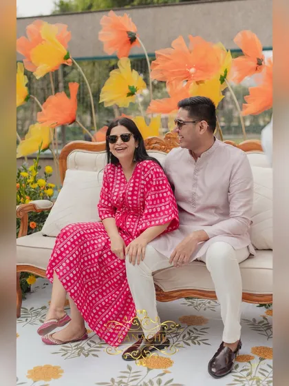 A candid moment of laughter between the couple during their Haldi photoshoot.
