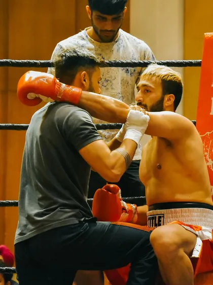 In the corner between rounds, listening to my coach. A fight is as much about strategy and composure as it is about physical strength.