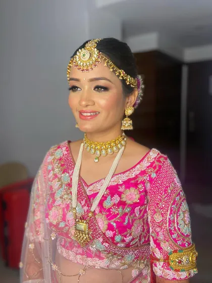Another angle of Pooja's timeless bridal look, showcasing the beautiful details of her makeup and hair.