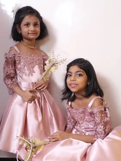 I created these matching dusty rose satin gowns for two sisters attending a wedding. The design features a delicate lace bodice with off-the-shoulder sleeves, blending modern style with timeless elegance for a truly special look.
