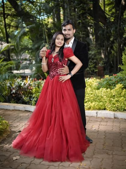 A classic pose for a timeless love. This couple chose a deep red ball gown and a classic black blazer for their elegant pre-wedding photos in a lush garden.