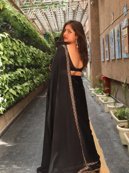 A classic black saree is always a good idea. This look is perfect for an evening Sangeet or reception, giving off elegant and timeless vibes.