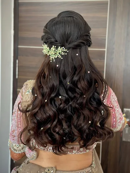 A detailed view of the reception hairstyle, featuring soft waves and delicate baby's breath flowers.