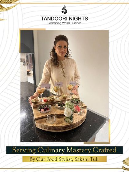We serve culinary mastery crafted by our food stylist, Sakshi Tuli. She is seen here presenting a beautiful wooden platter of assorted appetizers.