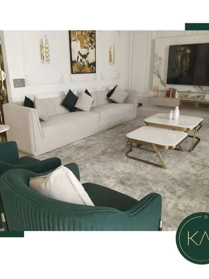 We designed this living space to be a sanctuary of modern elegance. The arrangement features a plush off-white sofa, complemented by deep green, channel-tufted accent chairs and dual marble-topped coffee tables, creating a sophisticated environment for relaxation and social gatherings.