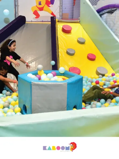 So much action in one spot! Kids slide, play, and interact around the ball pit, making it the heart of our play zone.