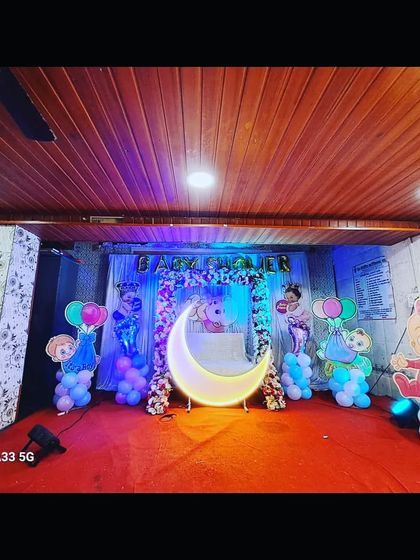A baby shower stage combining Cocomelon characters with a lighted moon prop, showing how I can mix and match themes based on your request.