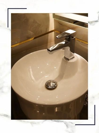 A close-up of a vessel sink with a modern chrome faucet. The combination of the round sink and the clean lines of the faucet creates a balanced and contemporary look.