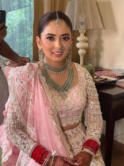 A candid moment during the getting-ready process. The skin looks luminous and healthy, which is the perfect base for a soft glam look that lasts all day.