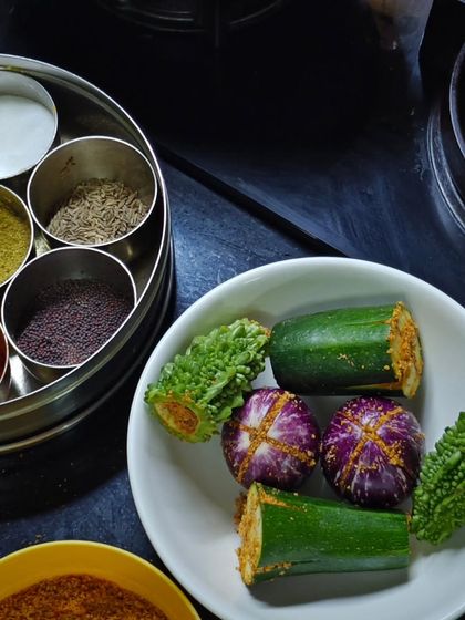 Even during festive seasons, we can't forget our vegetables! Here is the prep for Bharlela Vanga (stuffed eggplant) and Karela (bitter gourd), classic Maharashtrian vegetarian dishes.
