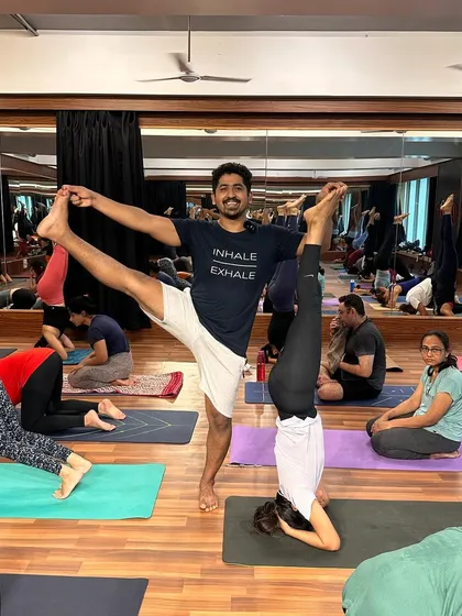 A fun moment from a workshop, combining my Utthita Hasta Padangusthasana with a student's headstand. This shows the trust and connection we build in our community.