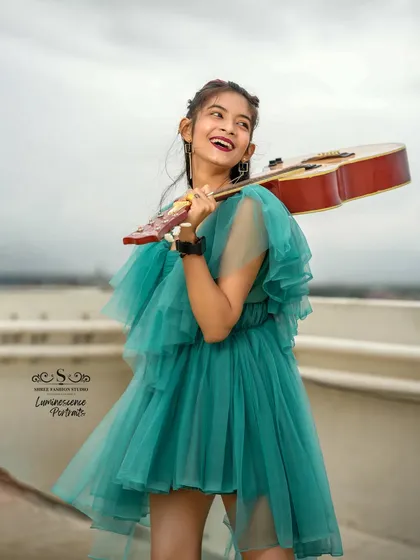 A joyful and carefree portrait of a musician, her wide smile capturing the happiness that music brings, with her guitar held like a dance partner.