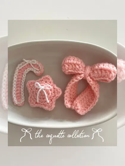 My "coquette collection" for the holidays, featuring a pink candy cane, a star with a tiny bow, and a signature large bow, all in a cute pink and white theme.