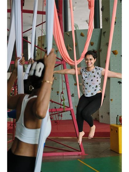 Two students share a laugh while practicing, highlighting the fun and social aspect of our community classes.