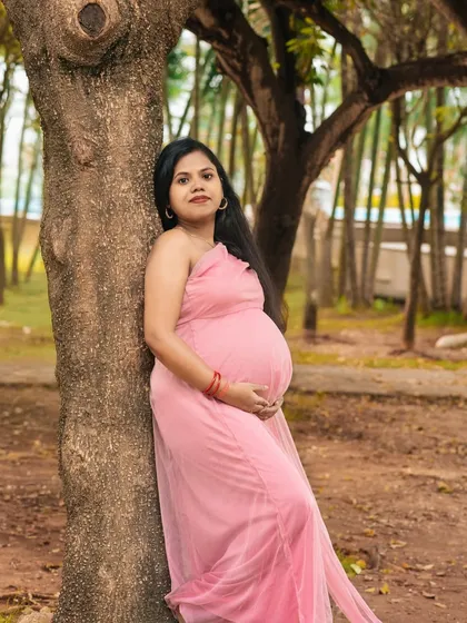 A serene solo portrait of an expectant mother in a beautiful park. The natural light and peaceful surroundings perfectly complement the beauty of this special time.