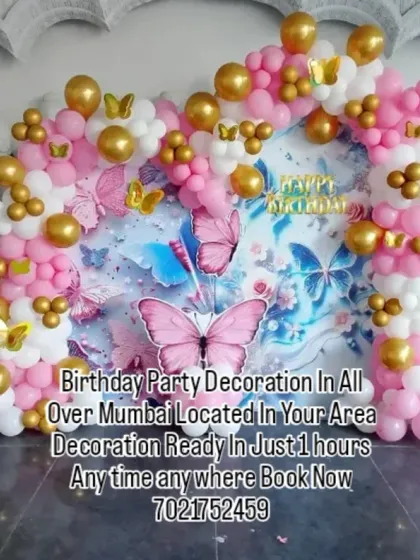 A lovely butterfly garden theme with a printed backdrop and matching balloon pillars. The pink, white, and gold balloons create a soft and pretty look for the celebration.