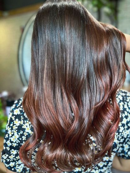 A rich copper touch balayage that adds warmth and vibrancy. This look was created with our no-bleach technique and paired with a complimentary haircut for a complete style refresh.