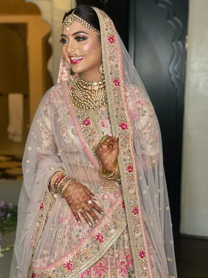 The smile of a happy bride says it all. Her makeup is glamorous yet feels light, allowing her natural beauty to shine through on her special day.