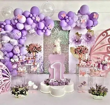 Celebrating a magical first birthday with a whimsical butterfly theme. This enchanting setup in shades of purple features a stunning dessert table, custom butterfly wing backdrops, and sparkling details to make the milestone unforgettable.