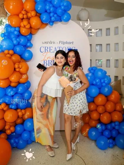 Guests enjoying the photo-op at the Wishlink x Flipkart event. The bold balloon arch in the brand's colors provided the perfect backdrop for creators to capture content.